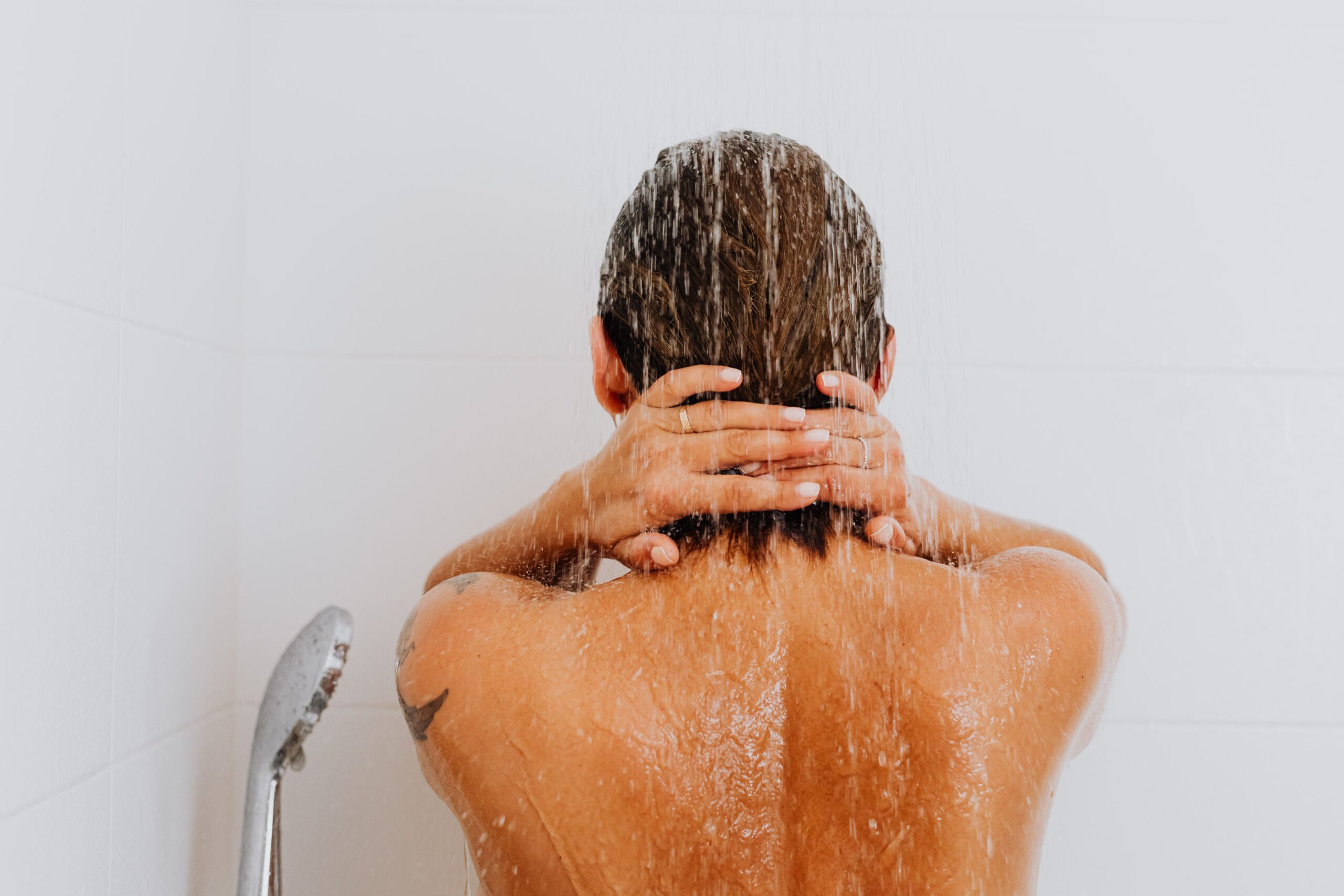 Personne sous une douche avec eau qui coule